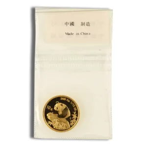 Gold Chinese Panda coin in protective packaging, featuring a panda design, marked with "999 Au" and "1/10 oz," indicating its purity and weight, with a label stating "Made in China."
