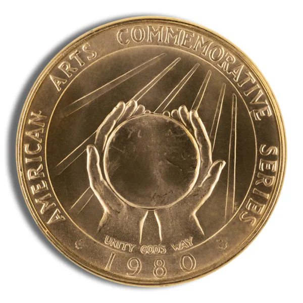 Gold commemorative coin featuring two hands supporting a globe, inscribed with "American Arts Commemorative Series" and the year "1980."