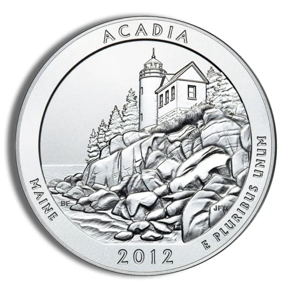 Silver coin featuring Acadia National Park's lighthouse in Maine, designed in 2012, showcasing detailed engravings of rocky coastline and surrounding trees.