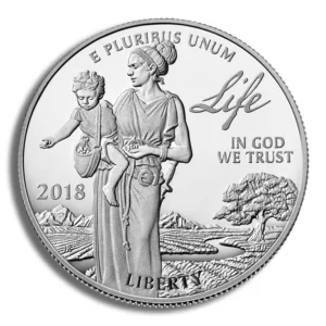 Silver coin featuring a woman carrying a child on her back, with the inscriptions "Life," "In God We Trust," "Liberty," and "2018." The design showcases a scenic background with mountains and trees, symbolizing family and hope.