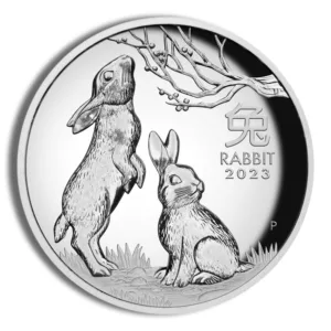 2023 silver coin featuring two rabbits, one standing and one sitting, under a tree with the inscription "Rabbit" and the year.