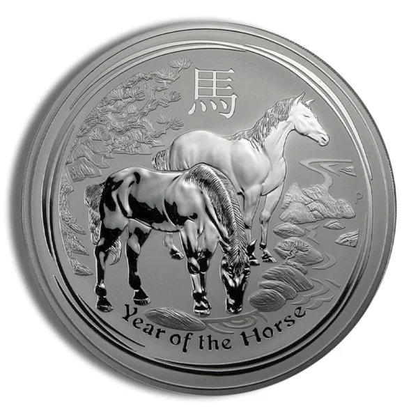 Silver coin featuring two horses, symbolizing the Year of the Horse in the Chinese zodiac, with intricate designs depicting a natural landscape.