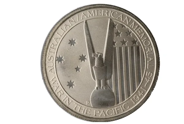 Alt text: Commemorative medal featuring an eagle and stars, inscribed with "Australian American Memorial," and dated 1941-45, symbolizing cooperation in the Pacific during World War II.