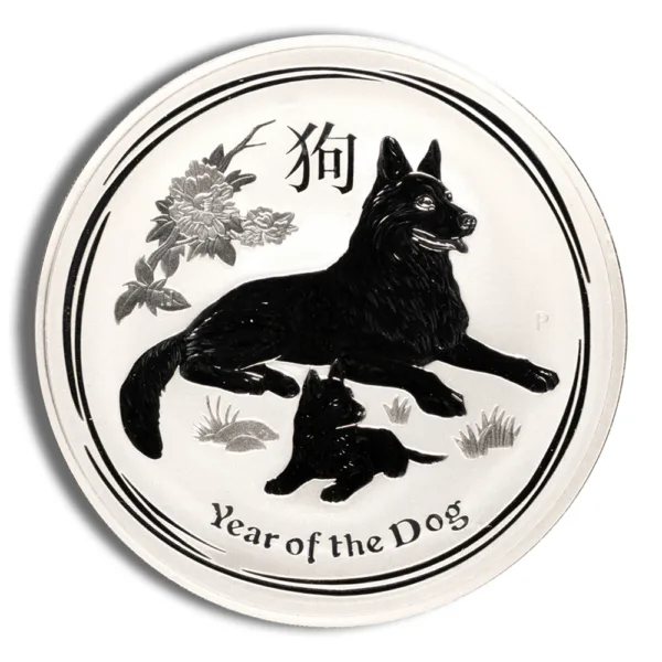 Silver coin featuring a black dog and puppy design, symbolizing the Year of the Dog in Chinese zodiac. The coin includes floral elements and inscriptions in both English and Chinese characters. Ideal for collectors and those celebrating the zodiac.