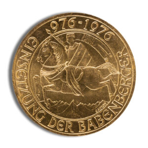 Gold commemorative coin featuring a knight on horseback, inscribed with "976-1976" and "GINSENZUNG DER BABENBERGER," representing the Babenberger dynasty's historical significance.