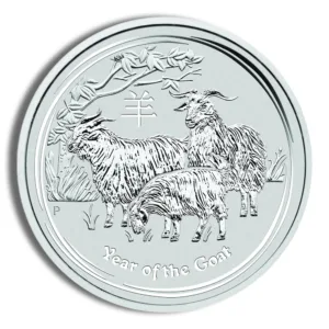 Silver coin depicting goats, representing the Year of the Goat in the Chinese zodiac, with intricate designs and a nature background.